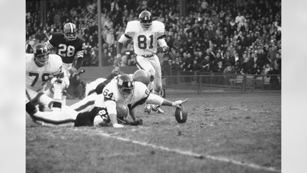 Guard Andy Gross (64) of the New York Giants reaches for an elusive pigskin  fumbled by Cleveland Browns Carl Ward (27) during a return of Giants  kickoff in the third quarter at