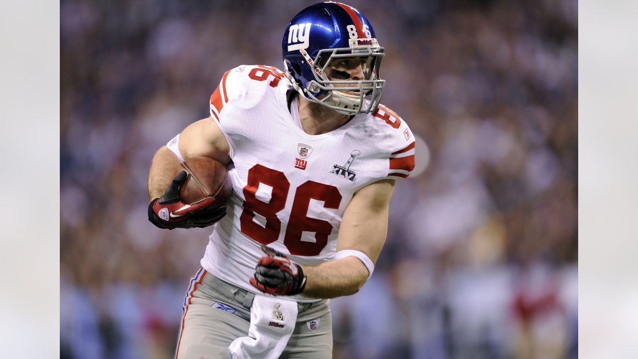 New England Patriots quarterback Tom Brady is hit by New York Giants  defensive end Justin Tuck as he throws a pass down field during Super Bowl  XLVI February 5, 2012, in Indianapolis.