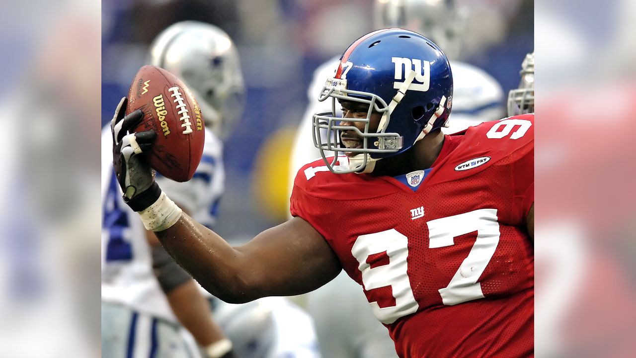 New York Giants defenders (91) Justin Tuck and (97) Kenderick Allen  celebrate a Dallas Cowboys turnover in week 13 at Giants Stadium in East  Rutherford, New Jersey on December 4, 2005. The