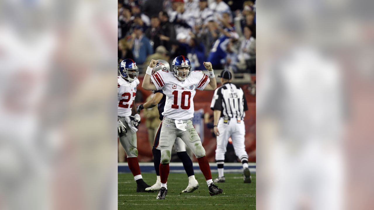 New York Giants quarterback Eli Manning escapes a sack by the New England  Patriots on fourth down and 6 during Super Bowl XLII at University of  Phoenix Stadium in Glendale, Arizona on