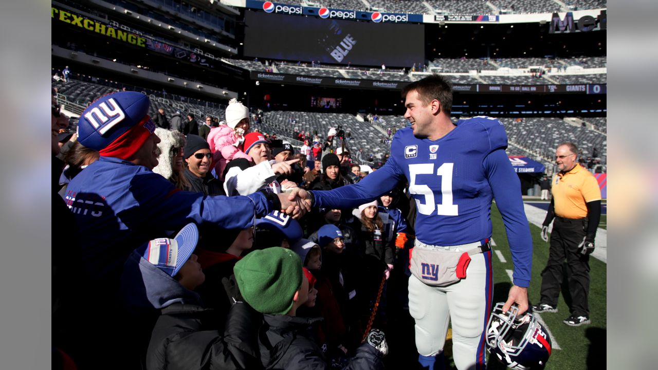 New York Giants line backer Zak DeOssie holds up a newspaper proclaiming  the Giants' win over the New England Patriots at Super Bowl XLII at  University of Phoenix Stadium in Glendale, Arizona