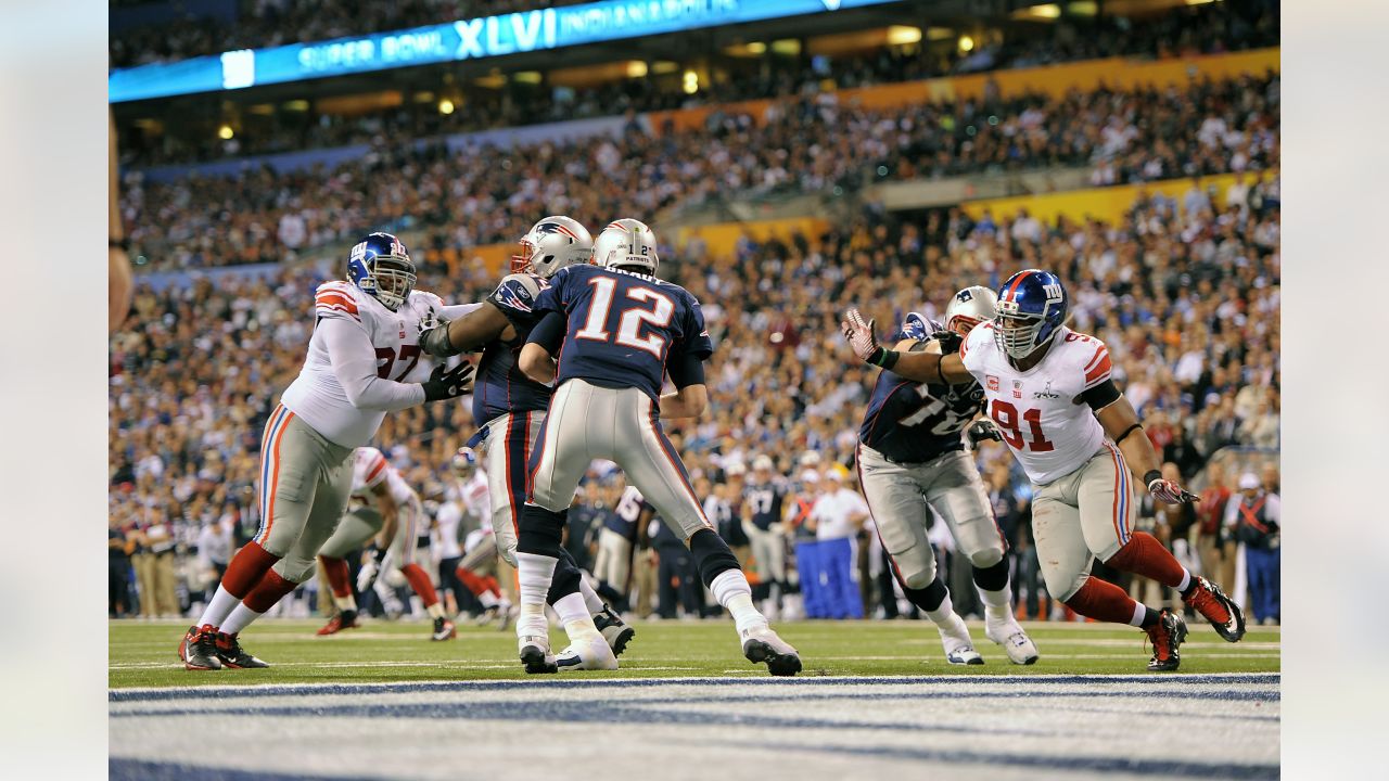 New England Patriots quarterback Tom Brady is pressured by New York Jets  Shaun Ellis in the fourth quarter of week 2 of the NFL season at Giants  Stadium in East Rutherford, New