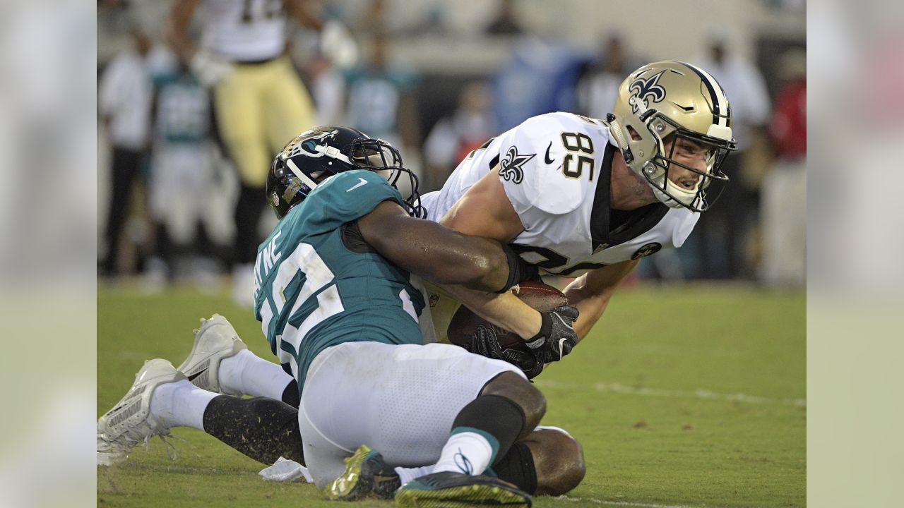 Jacksonville Jaguars running back Corey Grant, left, runs pass New Orleans  Saints linebacker Colton Jumper (58) during the first half of an NFL  preseason football game, Thursday, Aug. 9, 2018, in Jacksonville