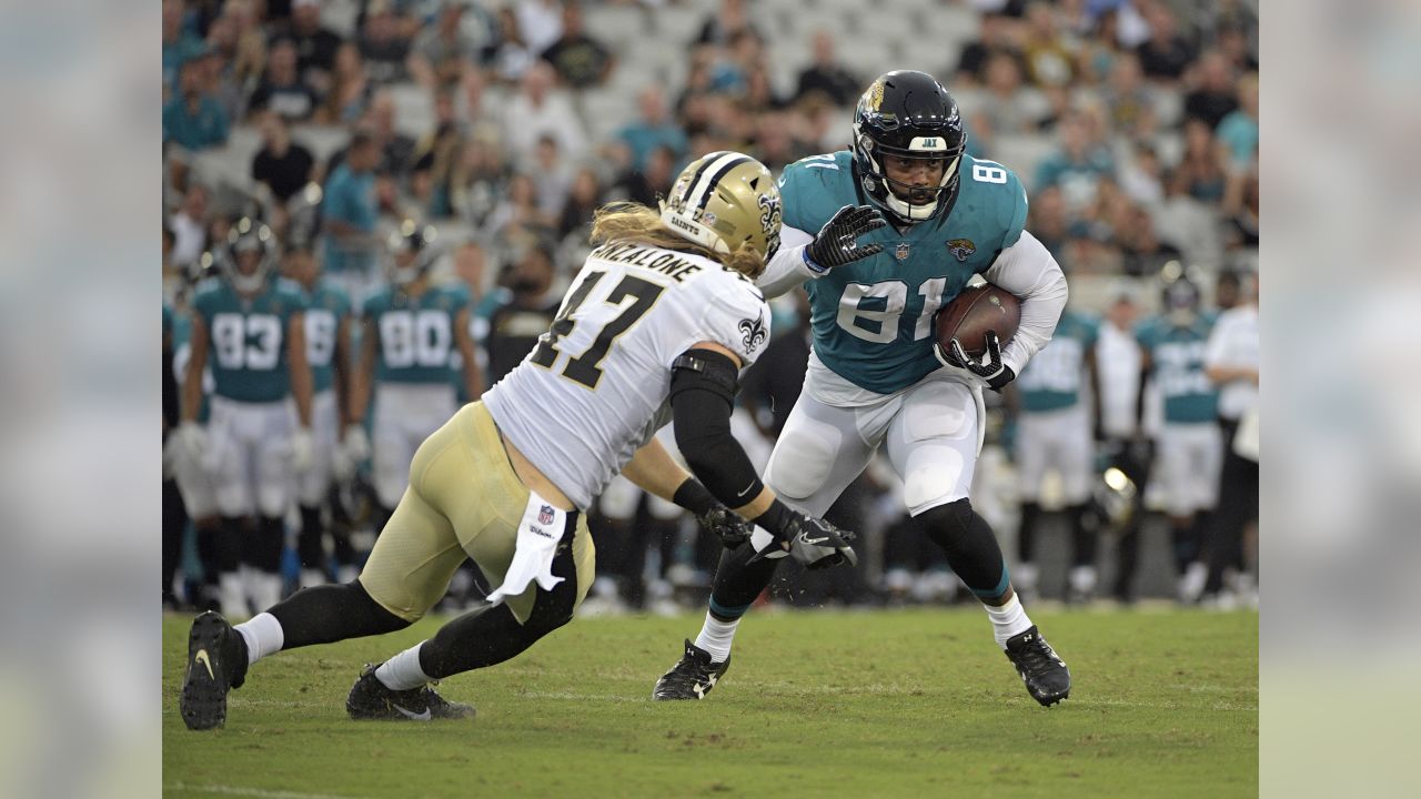 Jacksonville Jaguars running back Corey Grant, left, runs pass New Orleans  Saints linebacker Colton Jumper (58) during the first half of an NFL  preseason football game, Thursday, Aug. 9, 2018, in Jacksonville