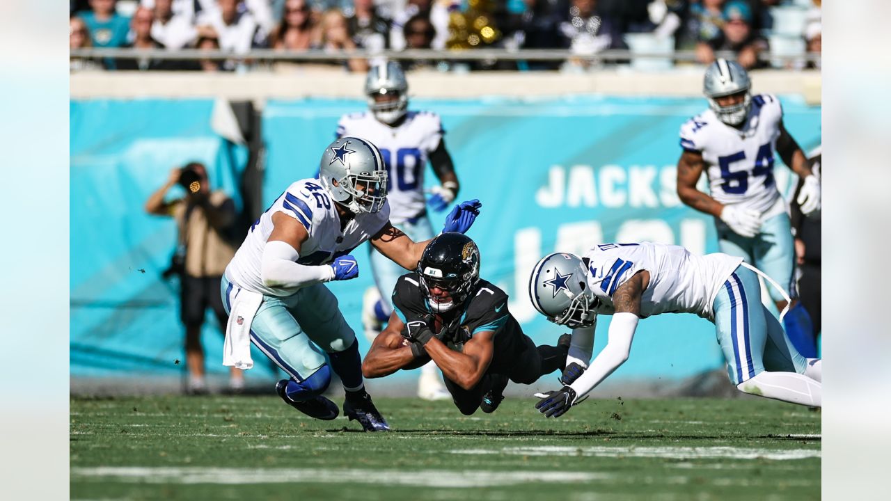 Jacksonville Jaguars offensive tackle Anton Harrison (76) defends against  Dallas Cowboys defensive tackle Osa Odighizuwa (97) during the first half  of an NFL preseason football game, Saturday, Aug. 12, 2023, in Arlington