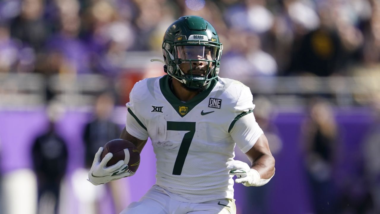 Baylor running back Trestan Ebner (1) leaps over TCU placekicker