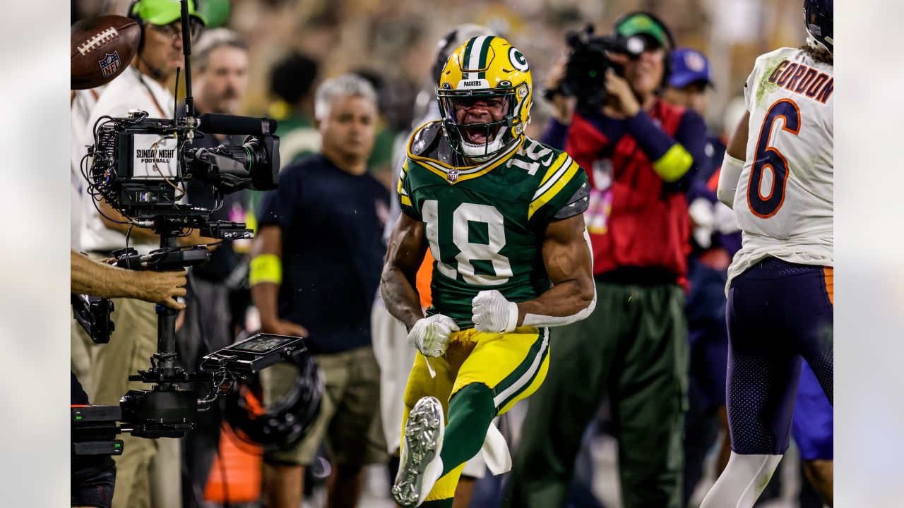 Dallas Cowboys' running back Emmitt Smith adjusts his mouth guard as he  checks the replay from the bench, in the second quarter against the Green  Bay Packers during their NFC playoff game