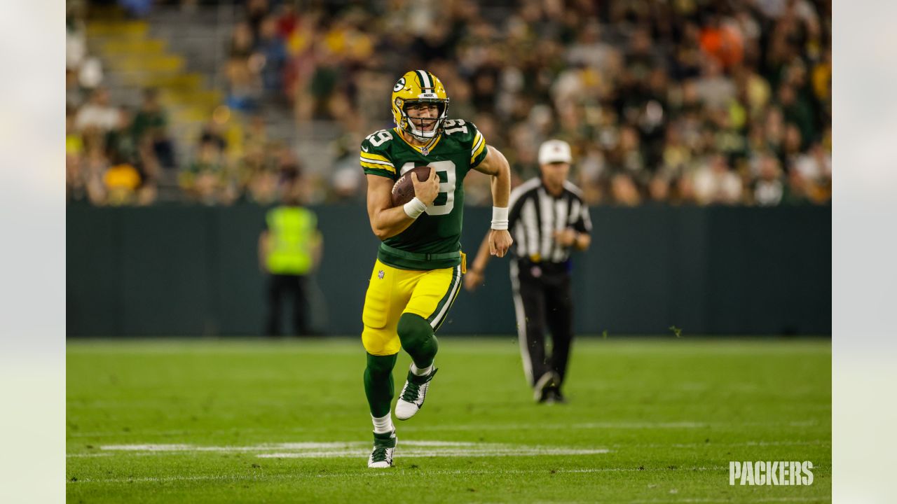 Green Bay Packers quarterback Danny Etling (19) runs for a touchdown during  an NFL Preseason game against the New Orleans Saints Friday, Aug. 19, 2022,  in Green Bay, Wis. (AP Photo/Jeffrey Phelps