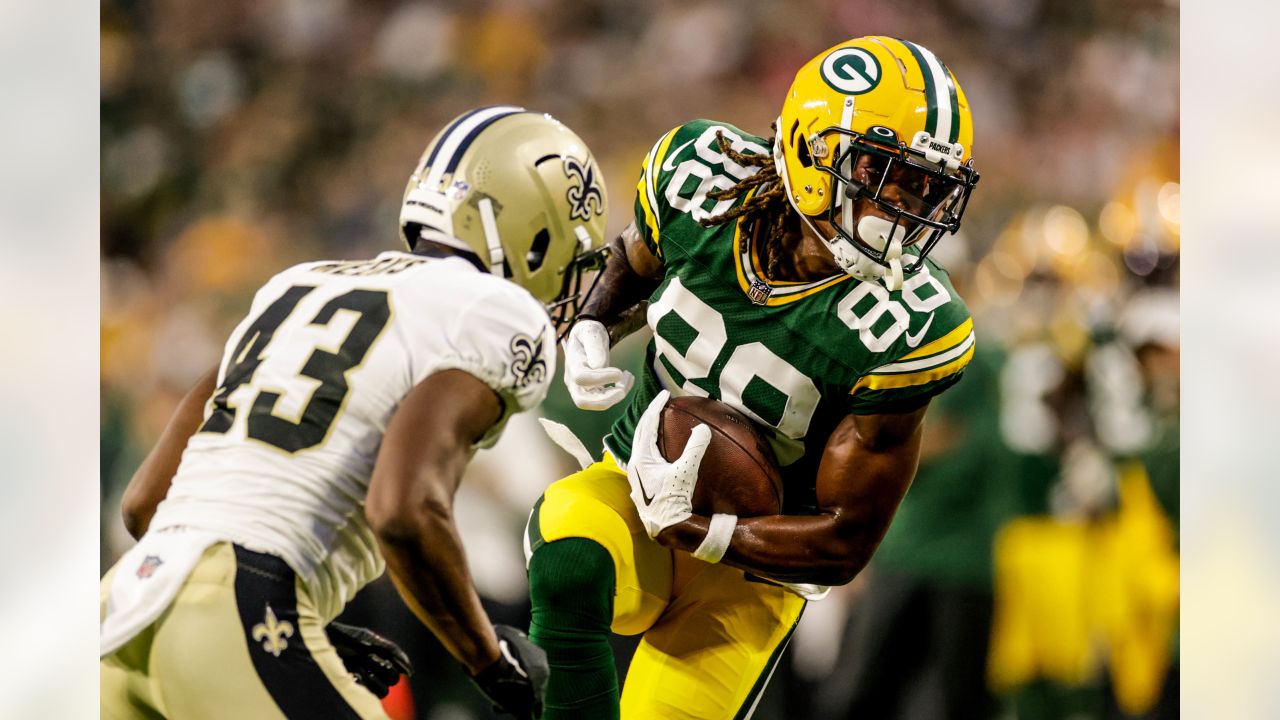 Green Bay Packers quarterback Danny Etling (19) runs for a touchdown during  an NFL Preseason game against the New Orleans Saints Friday, Aug. 19, 2022,  in Green Bay, Wis. (AP Photo/Jeffrey Phelps