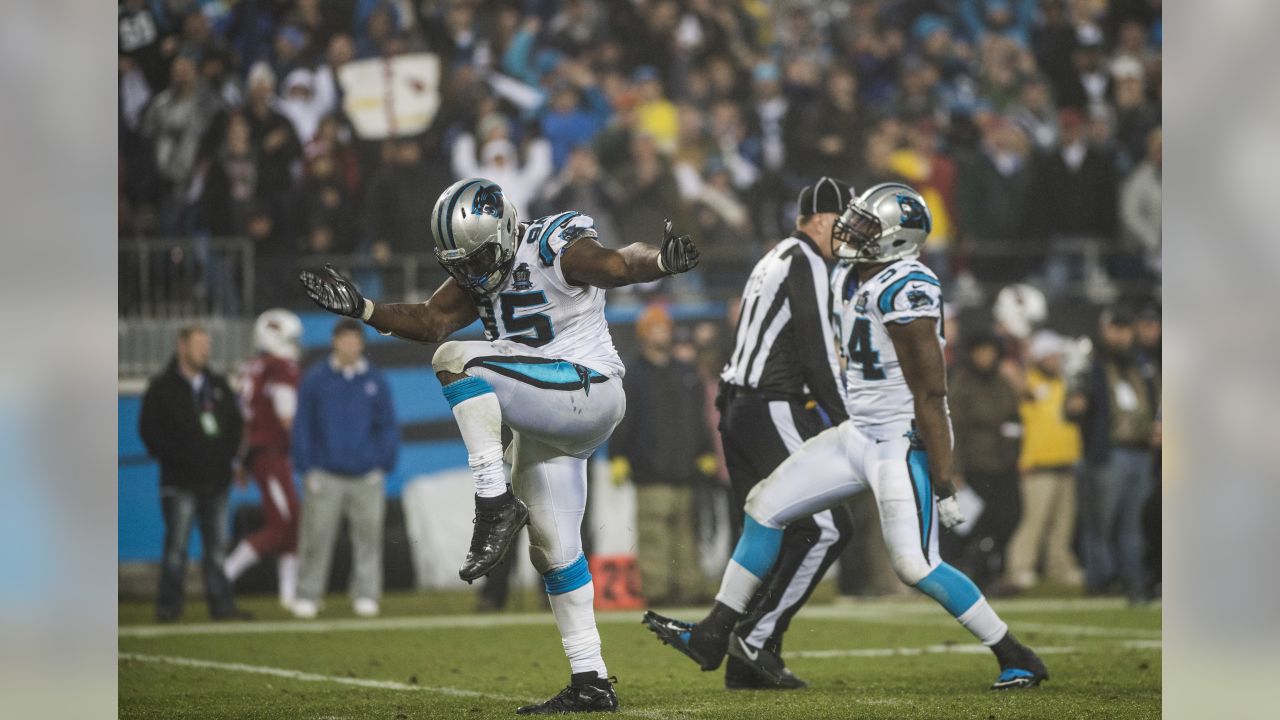 Carolina Panthers linebacker Thomas Davis lifts the NFC championship trophy  as he and defensive end Charles Johnson, left, celebrate after the Panthers  defeat the Arizona Cardinals 49-15 at Bank of America Stadium