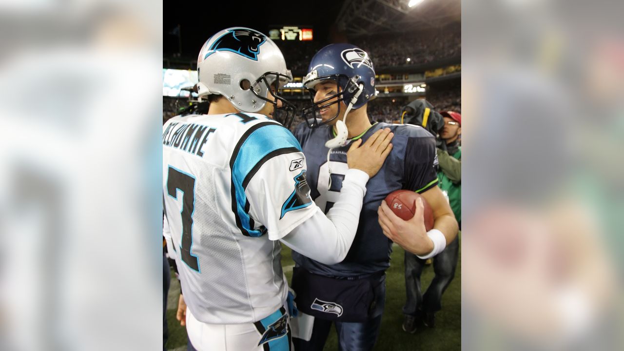 Carolina Panthers quarterback Jake Delhomme and wide receiver Steve Smith  (89) work to bring down Seattle Seahawks safety Michael Boulware after an  interception in the NFC Championship game at Qwest Field in