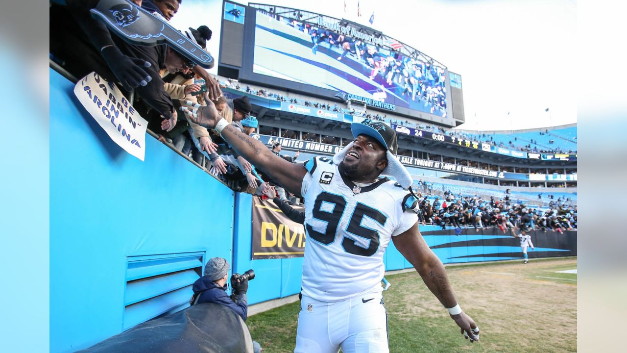 Carolina Panthers linebacker Thomas Davis lifts the NFC championship trophy  as he and defensive end Charles Johnson, left, celebrate after the Panthers  defeat the Arizona Cardinals 49-15 at Bank of America Stadium