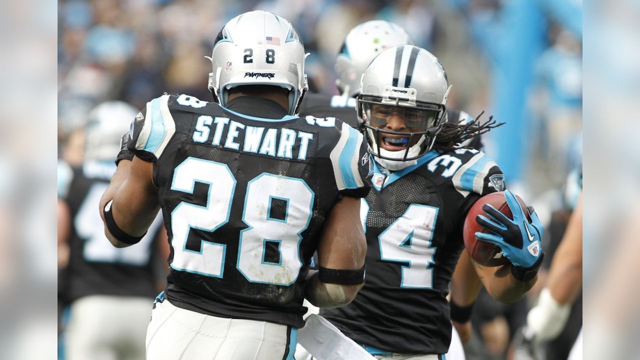 Carolina Panthers running back Jonathan Stewart, left, breaks free