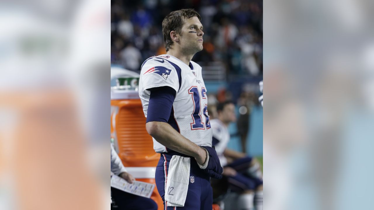 New England Patriots quarterback Tom Brady (12) cheers the offensive line  on the field, during the second half of an NFL football game against the  Miami Dolphins, Monday, Dec. 11, 2017, in