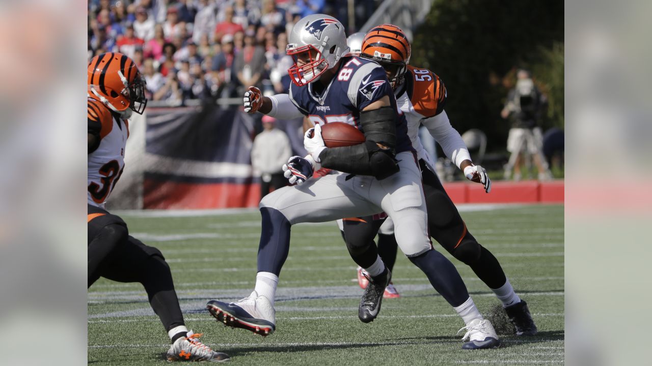 New England Patriots tight end Rob Gronkowski (87) runs from Cincinnati  Bengals defenders after catching a pass during the second half of an NFL  football game, Sunday, Oct. 16, 2016, in Foxborough