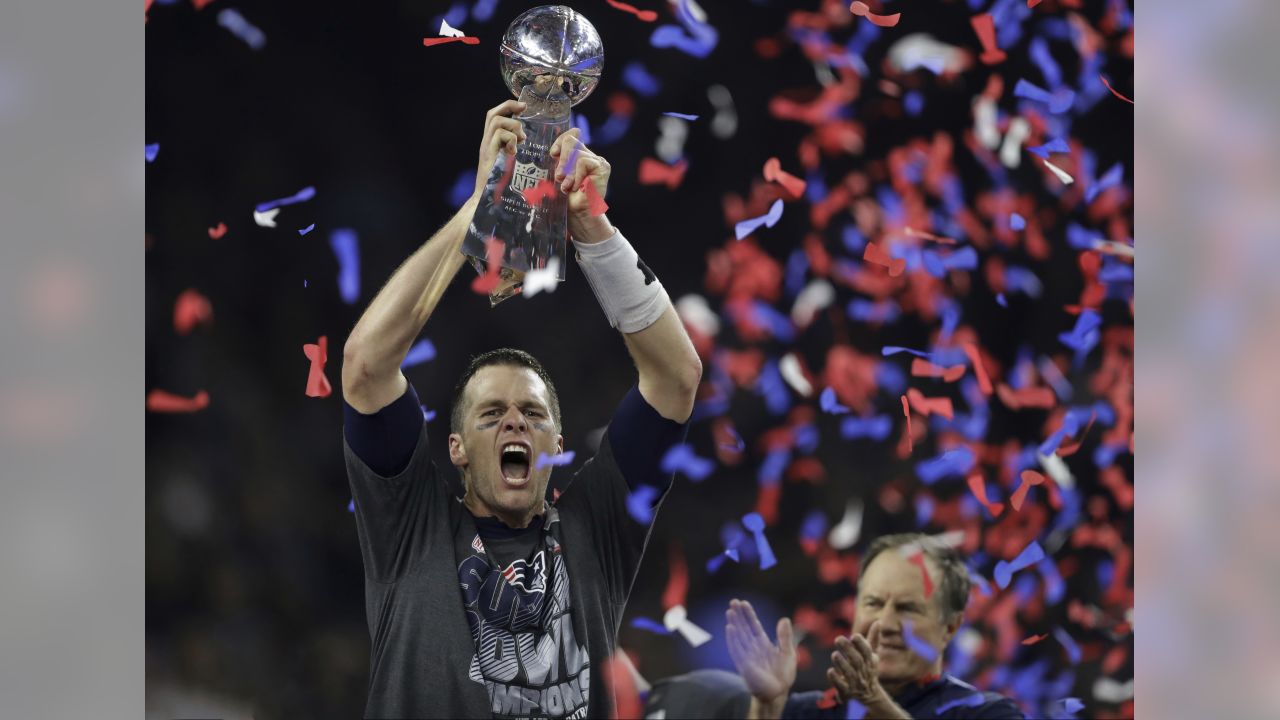 New England Patriots quarterback Tom Brady (L) hugs wide receiver Julian  Edelman after defeating the Atlanta Falcons in Super Bowl LI at NRG Stadium  in Houston on February 5, 2017. The Patriots