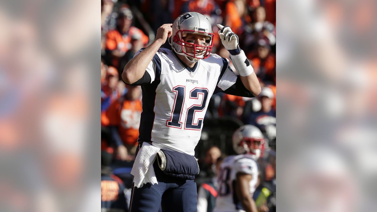 Tom Brady (12) of the New England Patriots throws a pass during the AFC  Championship game at Sports Authority Field at Mile High in Denver on  January 19, 2014. The New England-Denver