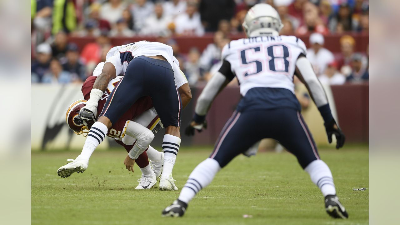 Washington Redskins outside linebacker Ryan Kerrigan (91) sacks New England  Patriots quarterback Tom Brady (12) during