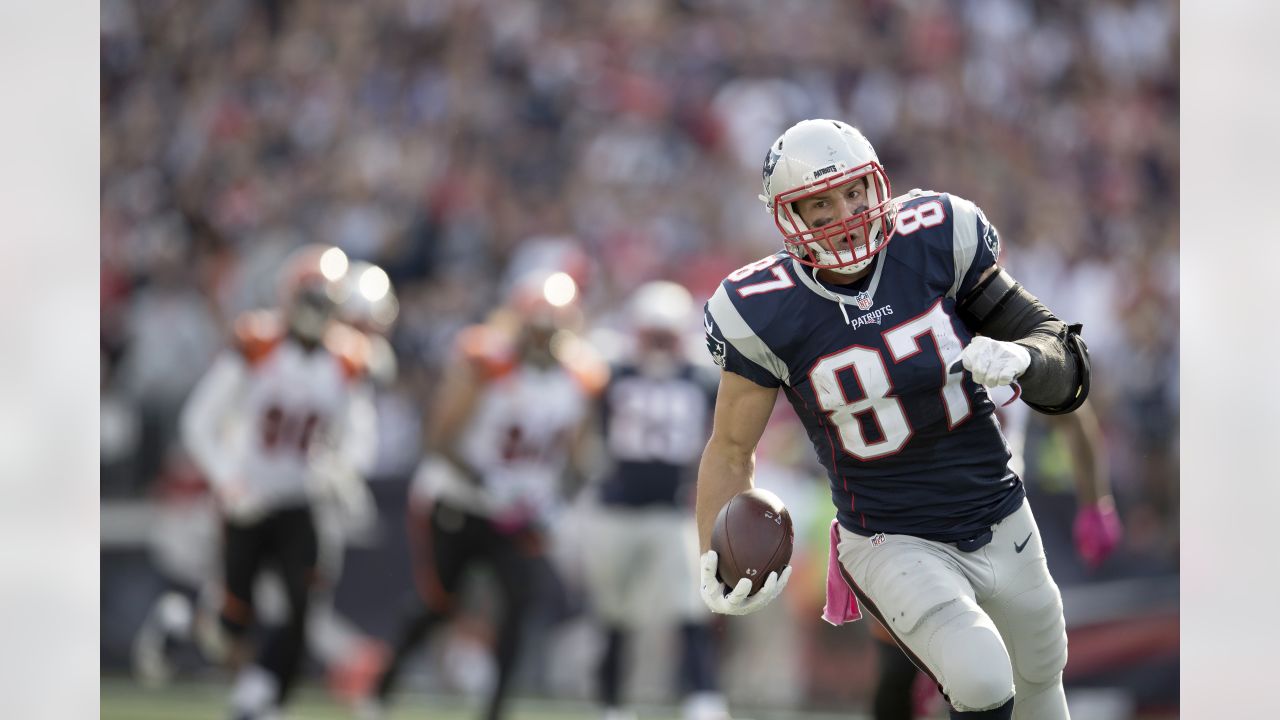 New England Patriots tight end Rob Gronkowski (87) runs from Cincinnati  Bengals defenders after catching a pass during the second half of an NFL  football game, Sunday, Oct. 16, 2016, in Foxborough