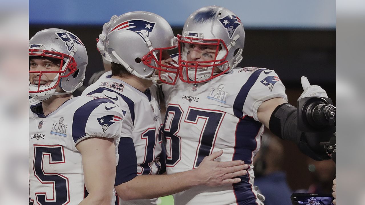 New England Patriots quarterback Tom Brady (12), tight end Rob Gronkowski ( 87), and Chris Hogan celebrate a touchdown pass to Gronkowski during the  fourth quarter of Super Bowl LII at U.S. Bank