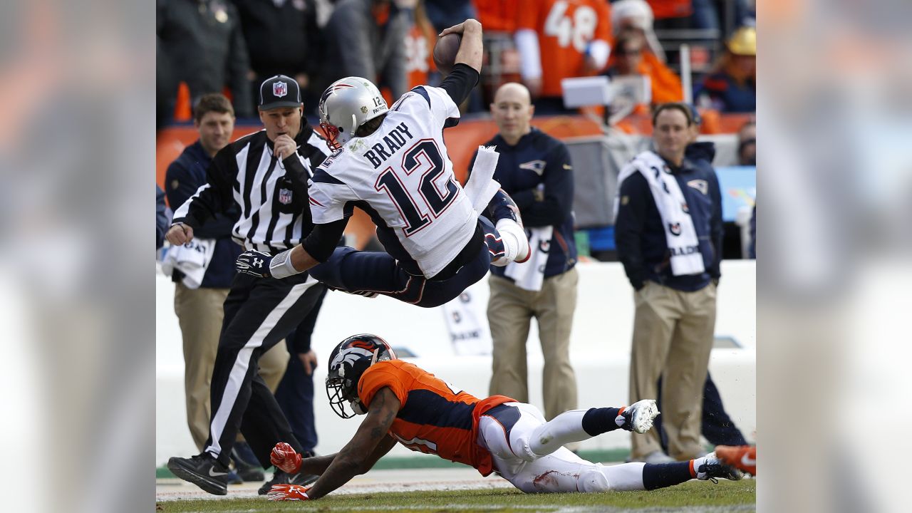 Tom Brady (12) of the New England Patriots passes during the AFC  Championship game at Sports Authority Field at Mile High in Denver on  January 19, 2014. The New England-Denver winner will