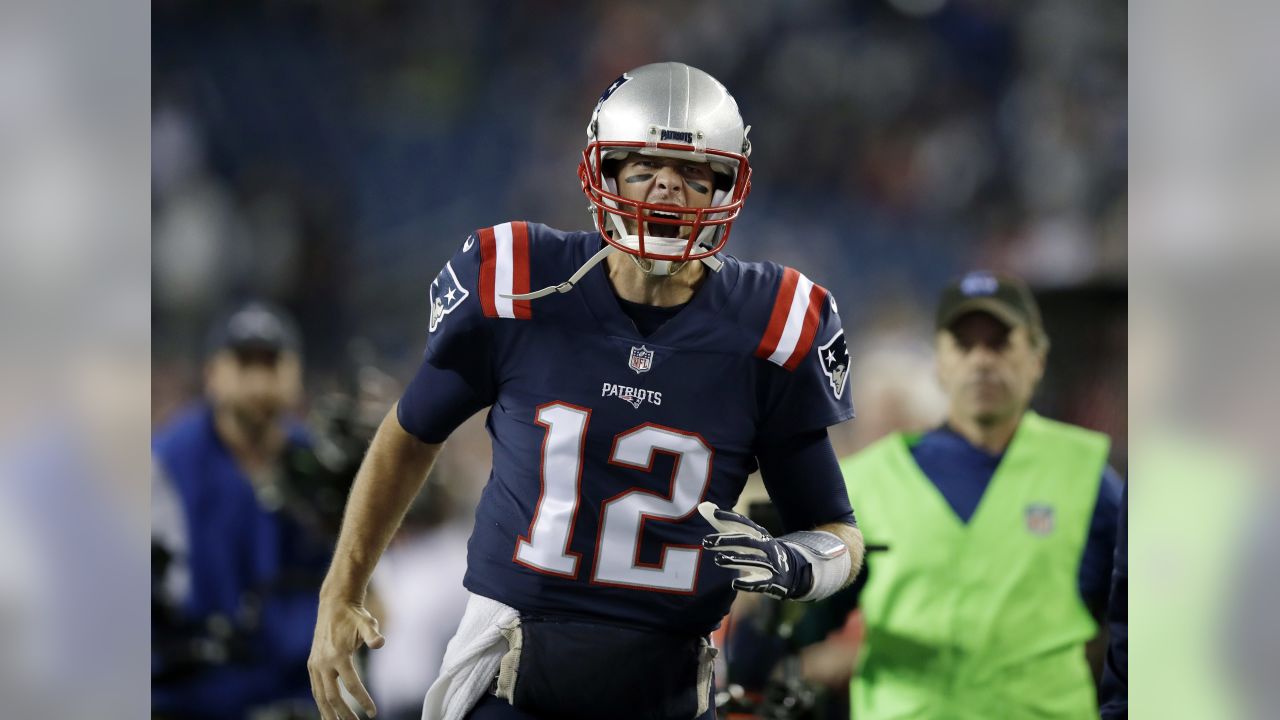 New England Patriots quarterback Tom Brady greets members of the U.S.  military along the sideline before an NFL football game against the Atlanta  Falcons, Sunday, Oct. 22, 2017, in Foxborough, Mass. (AP