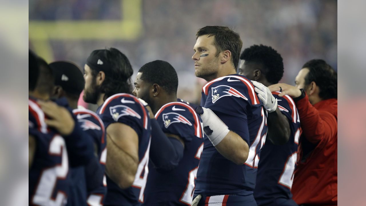 New England Patriots quarterback Tom Brady greets members of the U.S.  military along the sideline before an NFL football game against the Atlanta  Falcons, Sunday, Oct. 22, 2017, in Foxborough, Mass. (AP