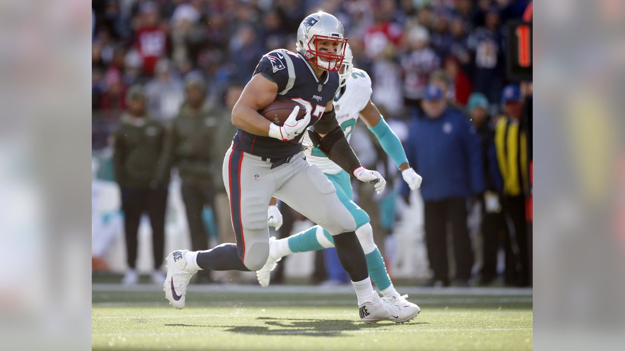 New England Patriots tight end Rob Gronkowski (87) is tripped up by Miami  Dolphins cornerback Will Allen (25) on a 9-yard reception in the fourth  quarter at Gillette Stadium in Foxboro, Massachusetts