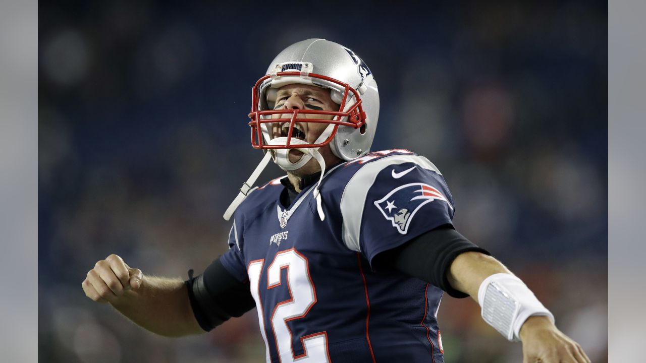 A fan walks by a giant helmet outside the New England Patriots Pro Shop  prior to an NFL football game, Sunday, Sept. 12, 2021, in Foxborough, Mass.  (AP Photo/Steven Senne Stock Photo 