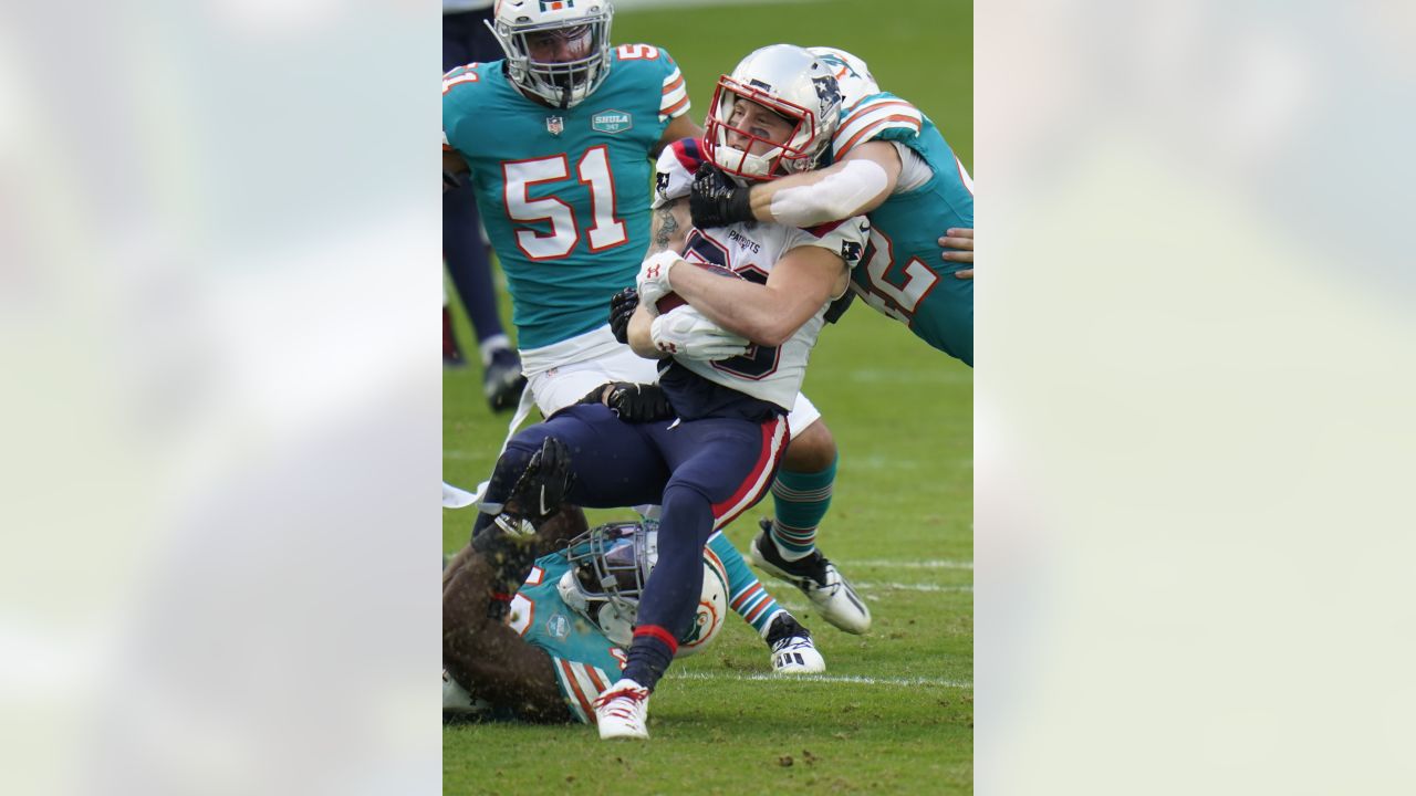 Miami Dolphins linebacker Sam Eguavoen (49) and Miami Dolphins