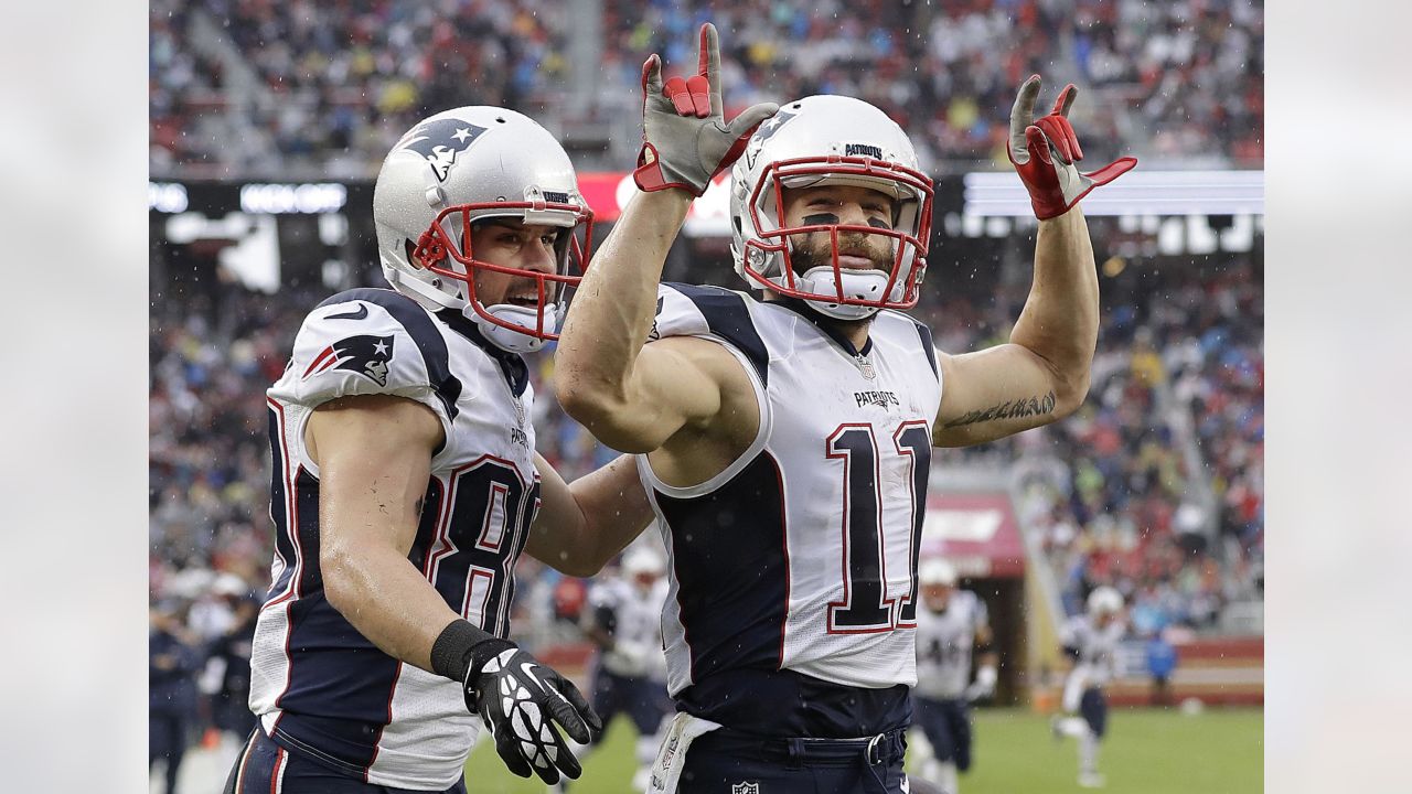 New England Patriots wide receiver Julian Edelman (11) holds up the  football after scoring a touchdown against the Denver Broncos