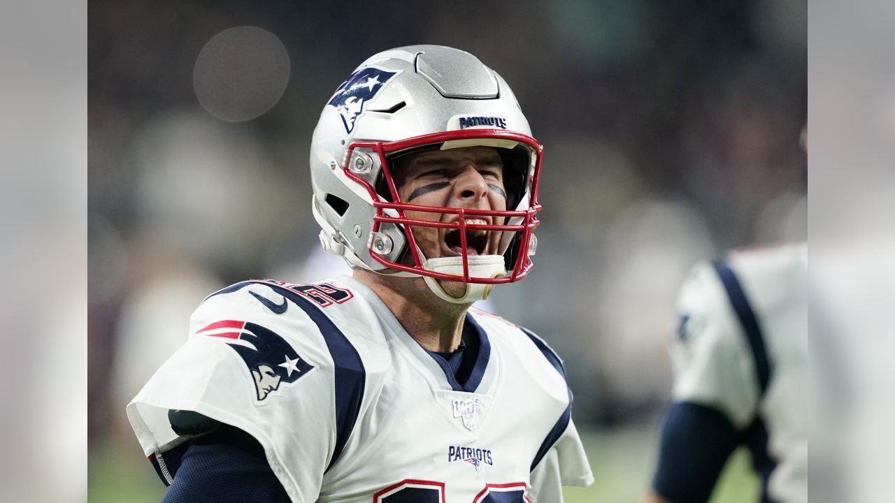 New England Patriots quarterback Tom Brady (12) passes over Chicago Bears  defensive end Lamarr Houston (99) in the first half of an NFL football game  on Sunday, Oct. 26, 2014, in Foxborough