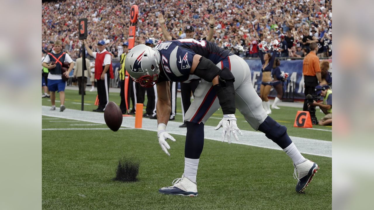 New England Patriots tight end Rob Gronkowski (87) finds open running room  against the Broncos on Sunday evening