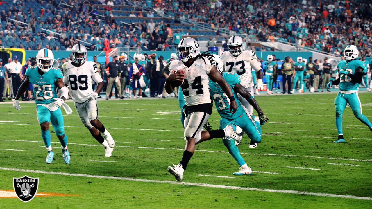 Oakland Raiders running back LaMont Jordan (34) is stopped by Miami  Dolphins tackle Chase Page (95) in second half action at Dolphin Stadium in  Miami on September 30, 2007. The Raiders defeated