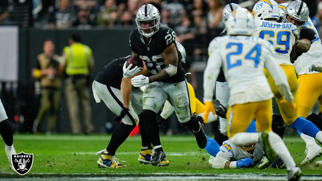 Las Vegas Raiders running back Josh Jacobs (28) gains yards on a run during  an NFL football game against the Los Angeles Chargers, Sunday, September  11, 2022 in Inglewood, Calif. The Chargers