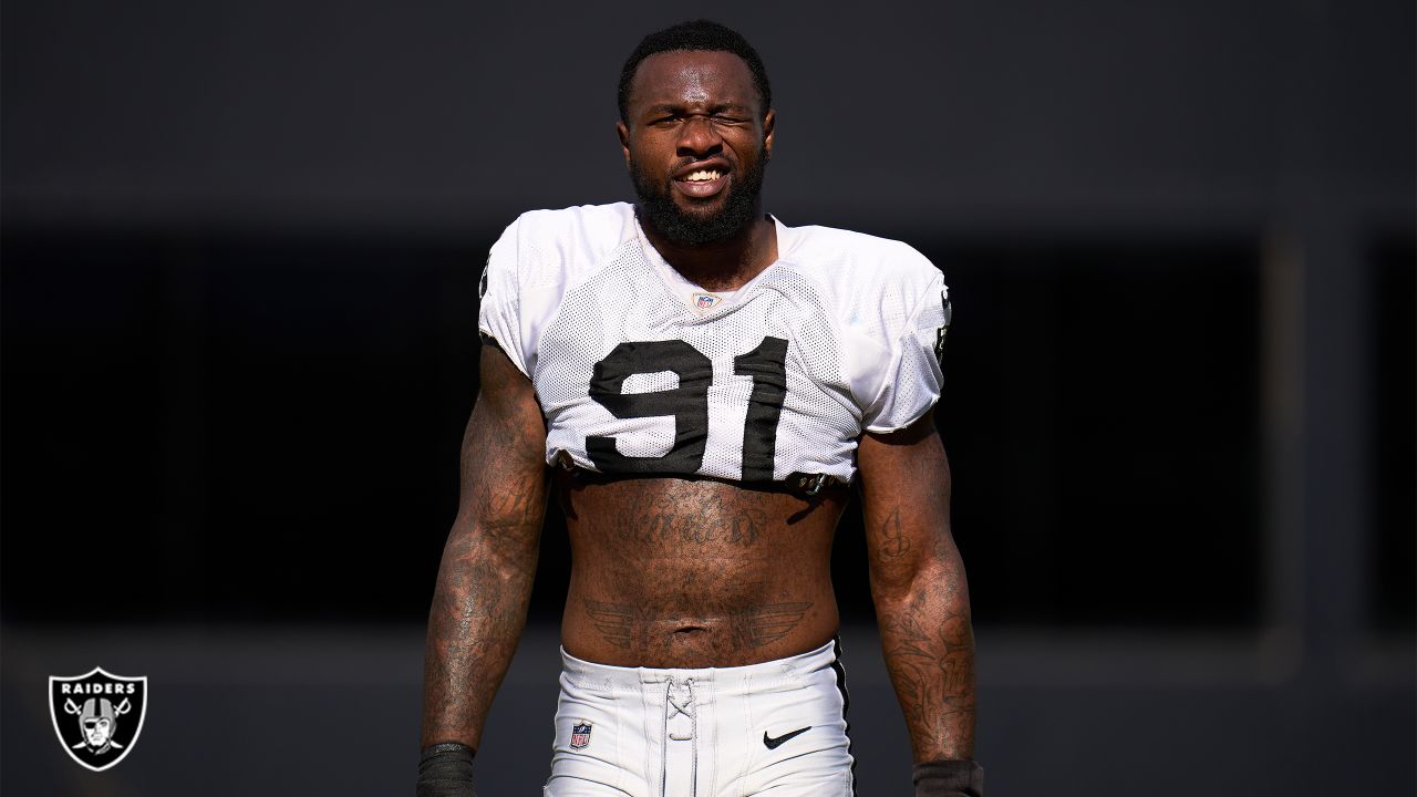 Raiders defensive end Yannick Ngakoue (91) confers with staff