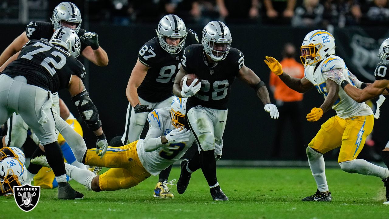 Las Vegas Raiders running back Josh Jacobs (28) gains yards on a run during  an NFL football game against the Los Angeles Chargers, Sunday, September  11, 2022 in Inglewood, Calif. The Chargers