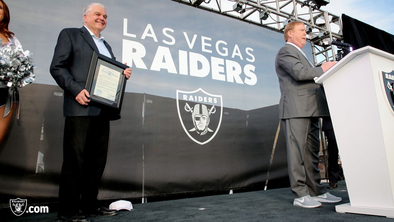 Las Vegas Raiders owner Mark Davis, center, speaks during a news  conference, officially renaming the Oakland Raiders to the Las Vegas Raiders,  in front of Allegiant Stadium in Las Vegas Wednesday, Jan.