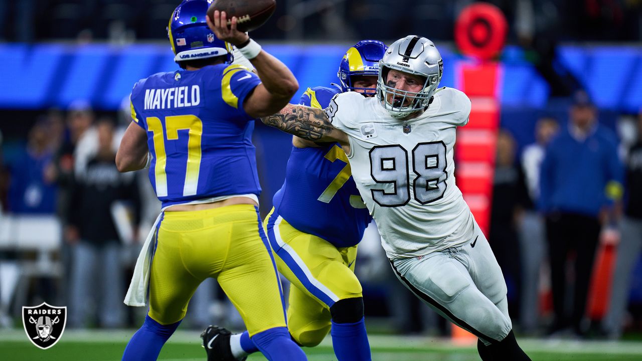 Oakland Raiders defensive end Maxx Crosby (98) gestures after being  penalized for roughing the …