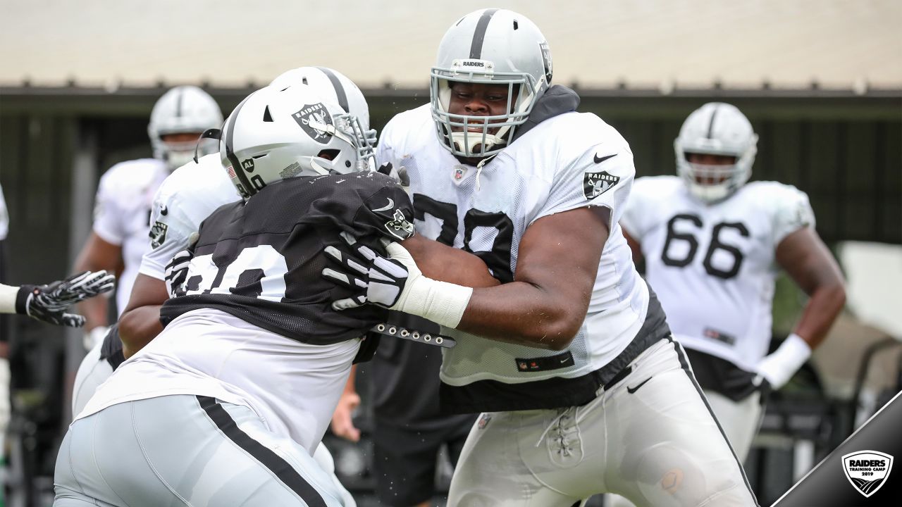 Oakland Raiders offensive guard Jordan Devey (65), center Richie Incognito  (64), and offensive …