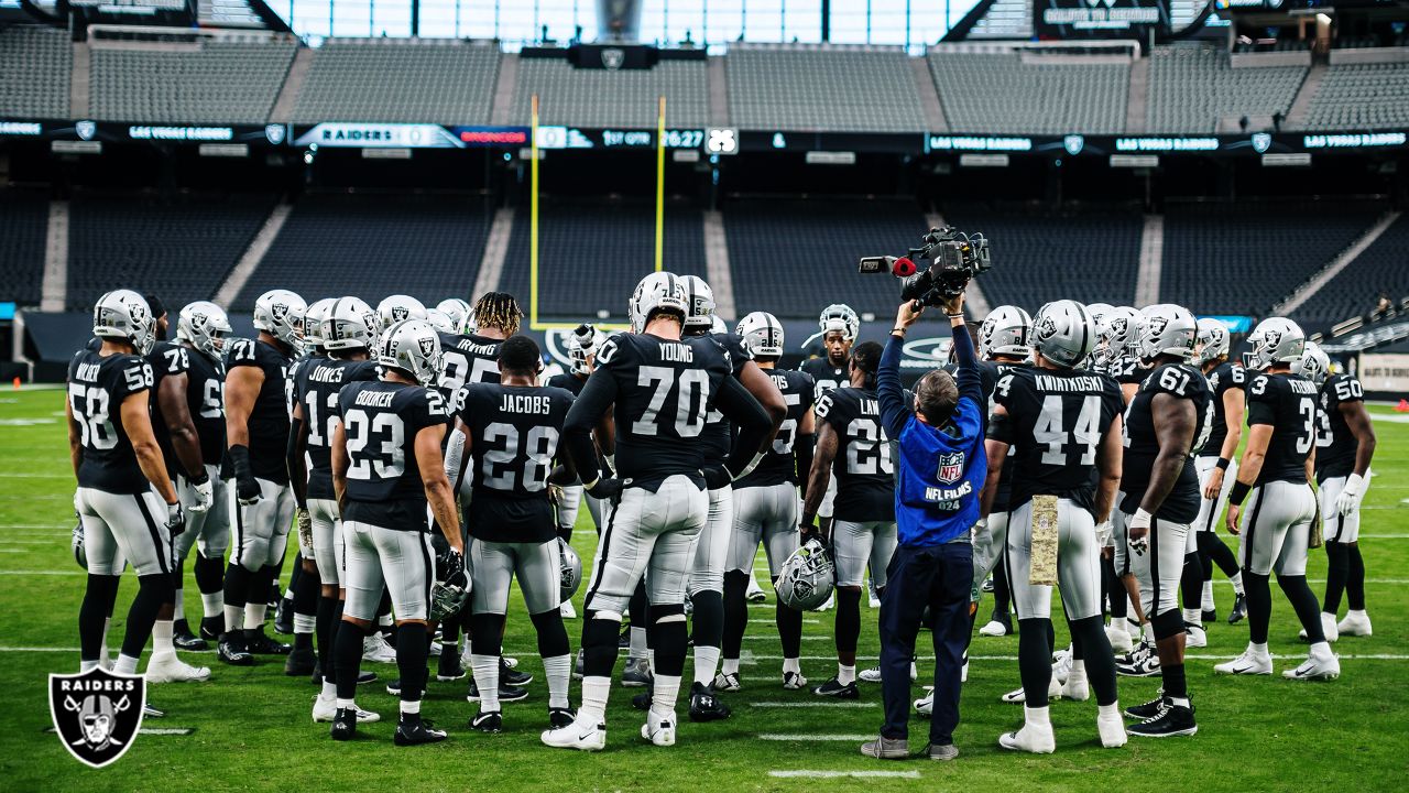 Las Vegas Raiders players huddle before the start of a NFL