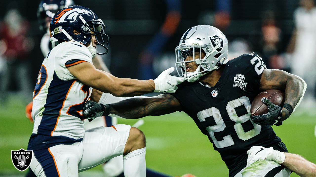 Las Vegas Raiders running back Josh Jacobs (28) stiff arms New York Giants  cornerback James Bra …