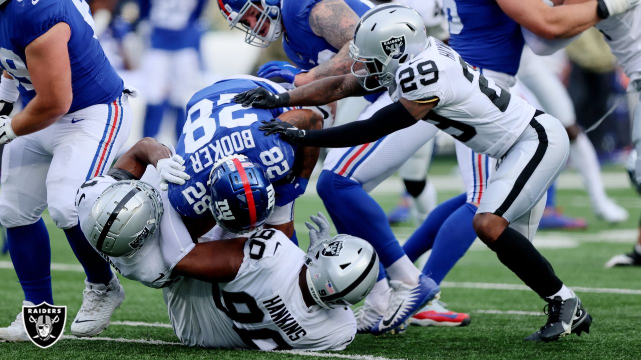 Houston Texans defensive tackle Thomas Booker IV (56) in between plays  during the first half of an NFL football game against the Las Vegas  Raiders, Sunday, Oct 23, 2022, in Las Vegas. (