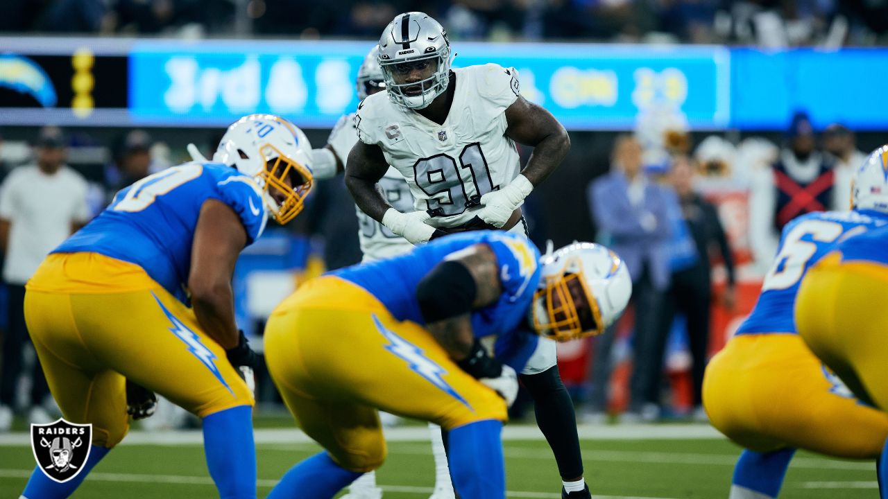 Las Vegas Raiders defensive end Yannick Ngakoue (91) breaks up a pass  attempt by Chicago Bears …