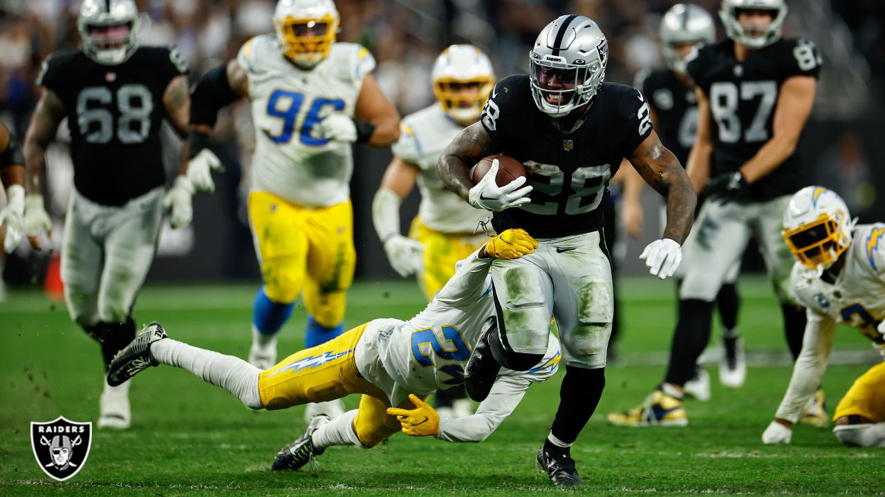 Las Vegas Raiders running back Josh Jacobs (28) gains yards on a run during  an NFL football game against the Los Angeles Chargers, Sunday, September  11, 2022 in Inglewood, Calif. The Chargers