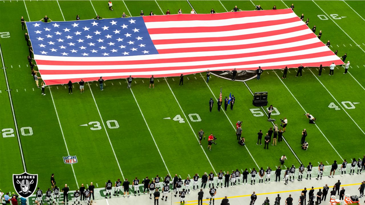 Fans wave team flags at an NFL game between the Oakland Raiders and the  Chicago Bears at Totten …