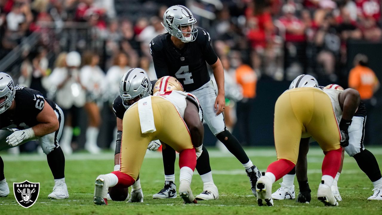 Las Vegas Raiders quarterback Aidan O'Connell (4) hands the ball