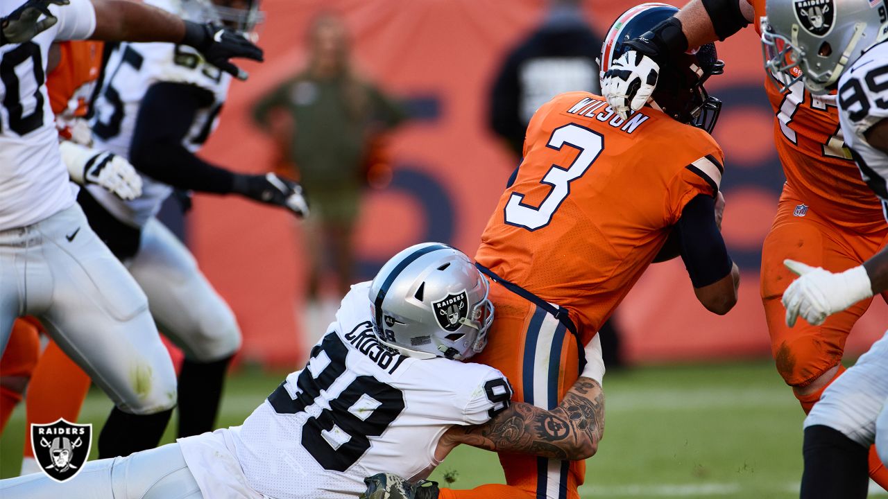 Oakland Raiders defensive end Maxx Crosby (98) gestures after being  penalized for roughing the …