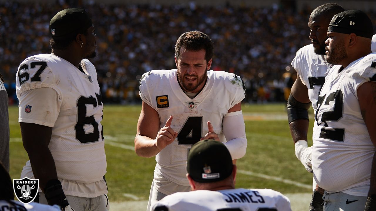 Oakland Raiders quarterback Derek Carr (4) talks on the sideline