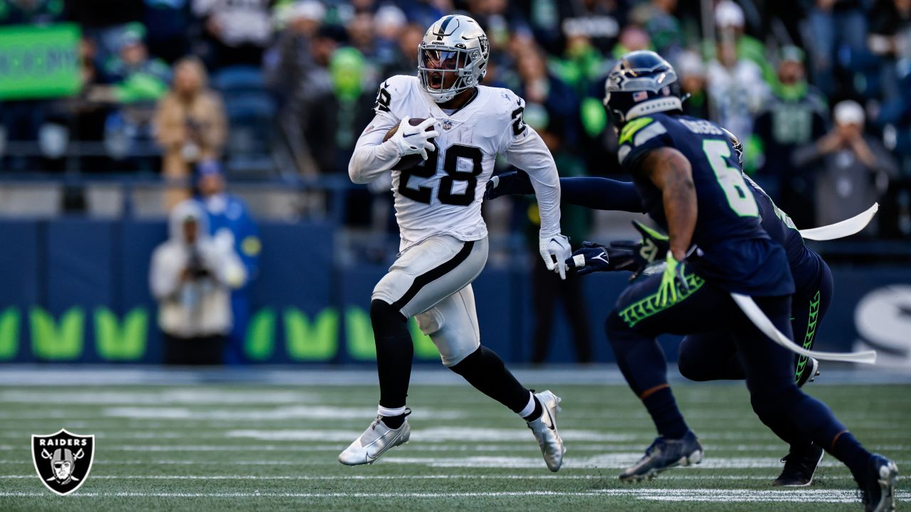 Las Vegas Raiders running back Josh Jacobs (28) smiles as he walks toward  the bench in the 4th …